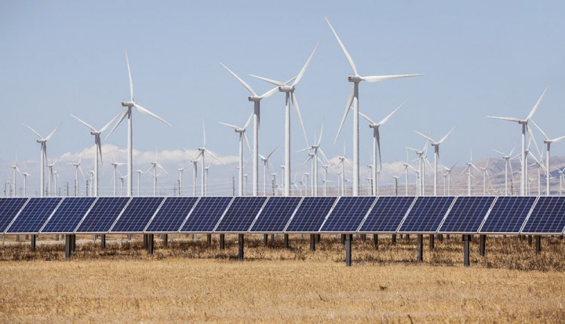 Wind mills and solar panels alternative energy production.