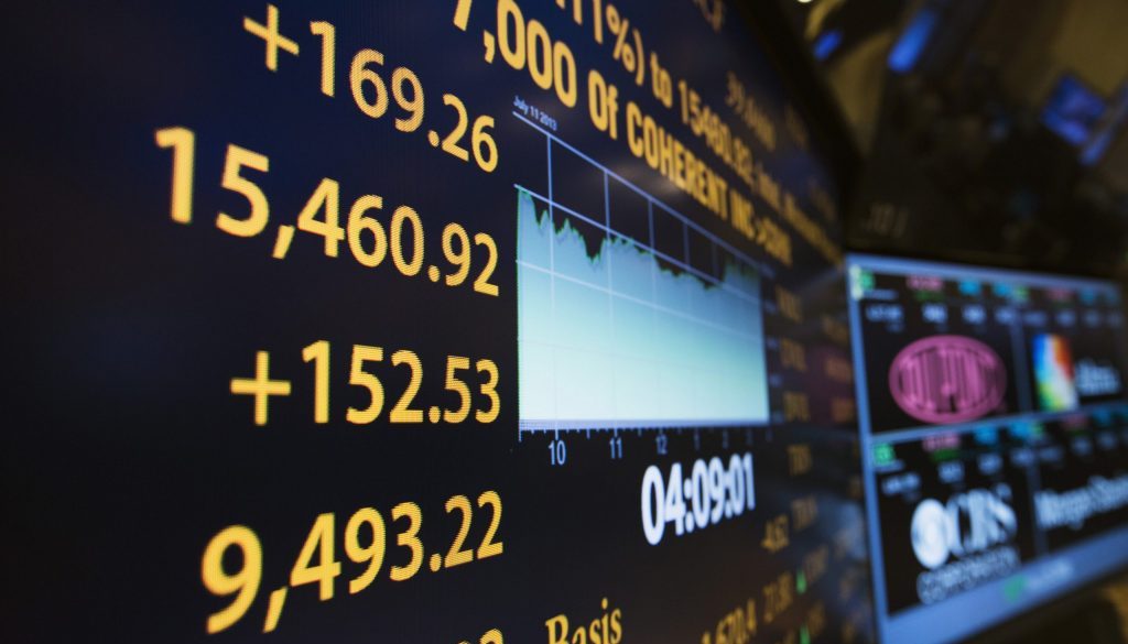 The day's final numbers are shown on information board above floor of New York Stock Exchange shortly before closing of market in New York