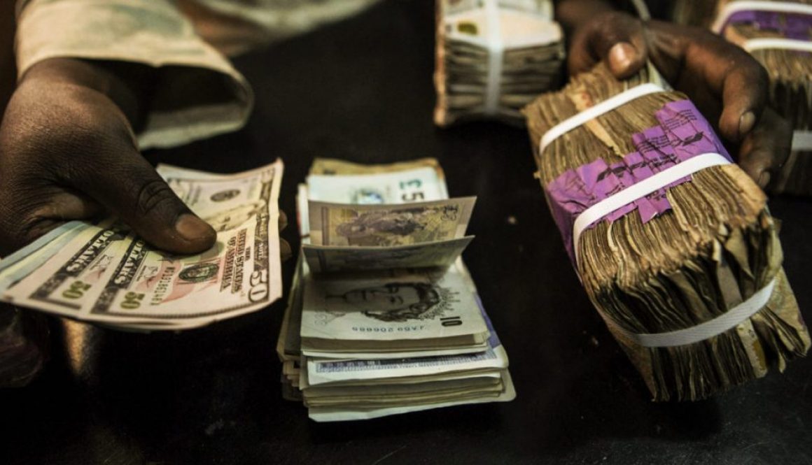 A trader changes dollars with naira at a currency exchange store in Lagos
