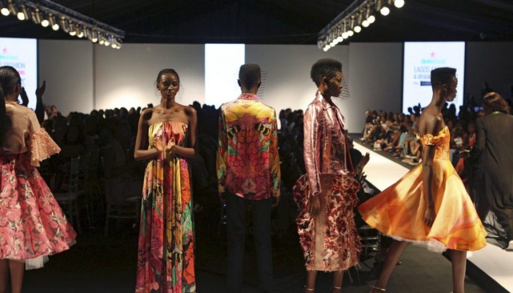 Models wearing clothes by design Onalaja pose on the runway during Lagos Fashion and Design Week in Lagos