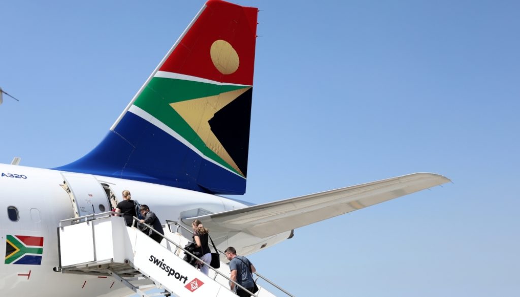 FILE PHOTO: Passengers board a South African Airways plane at the Port Elizabeth International Airport in the Eastern Cape province