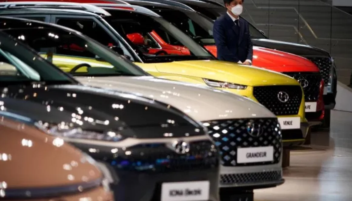 An-employee-wearing-a-mask-to-prevent-contracting-the-coronavirus-disease-COVID-19-waits-for-customers-next-to-a-Hyundai-Motors-vehicle-at-Hyundai-Motor-Studio-in-Goyang