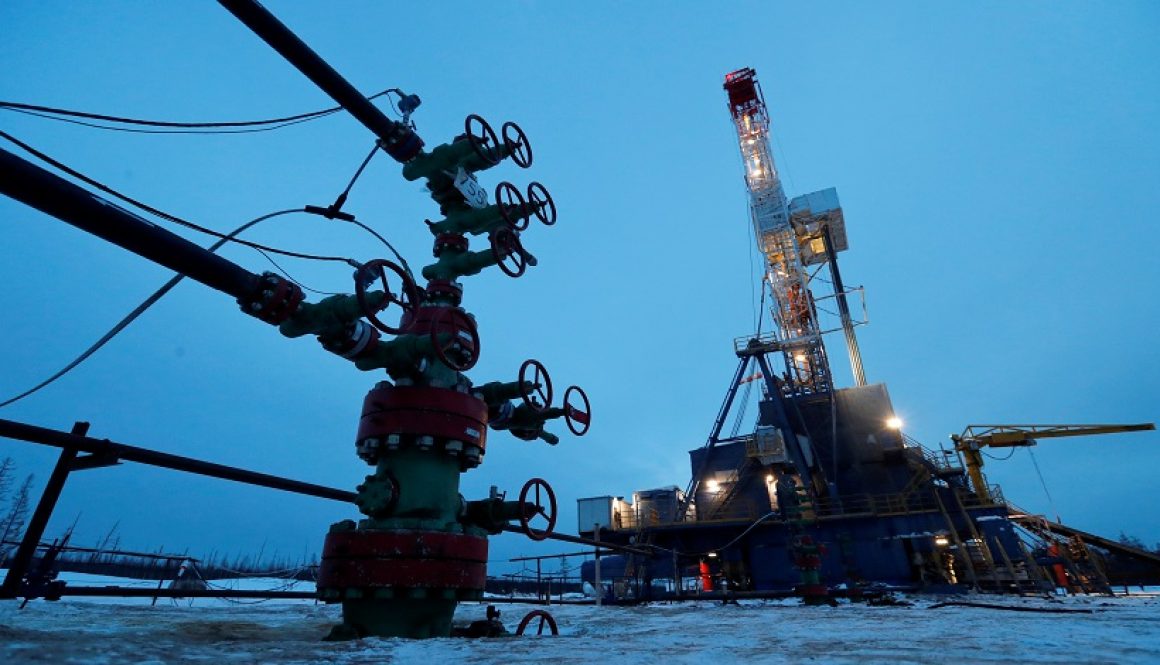 FILE PHOTO: A view shows a well head and a drilling rig in the Irkutsk Oil Company-owned Yarakta Oil Field in Irkutsk Region